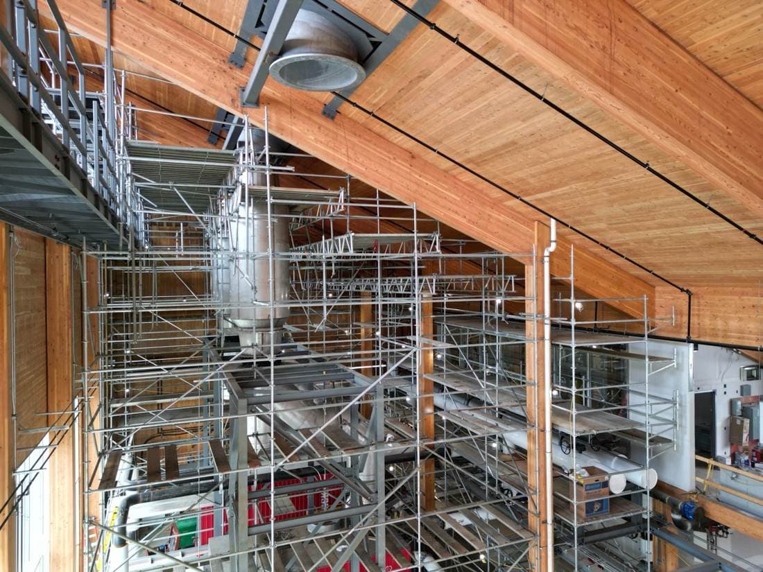 Complex interior scaffold under a timber ceiling