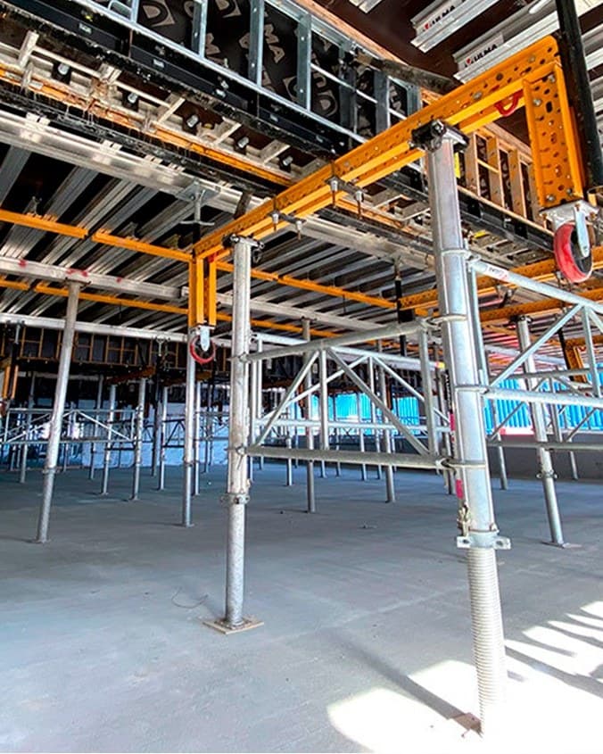 Slab formwork carried on drophead beams and adjustable steel props