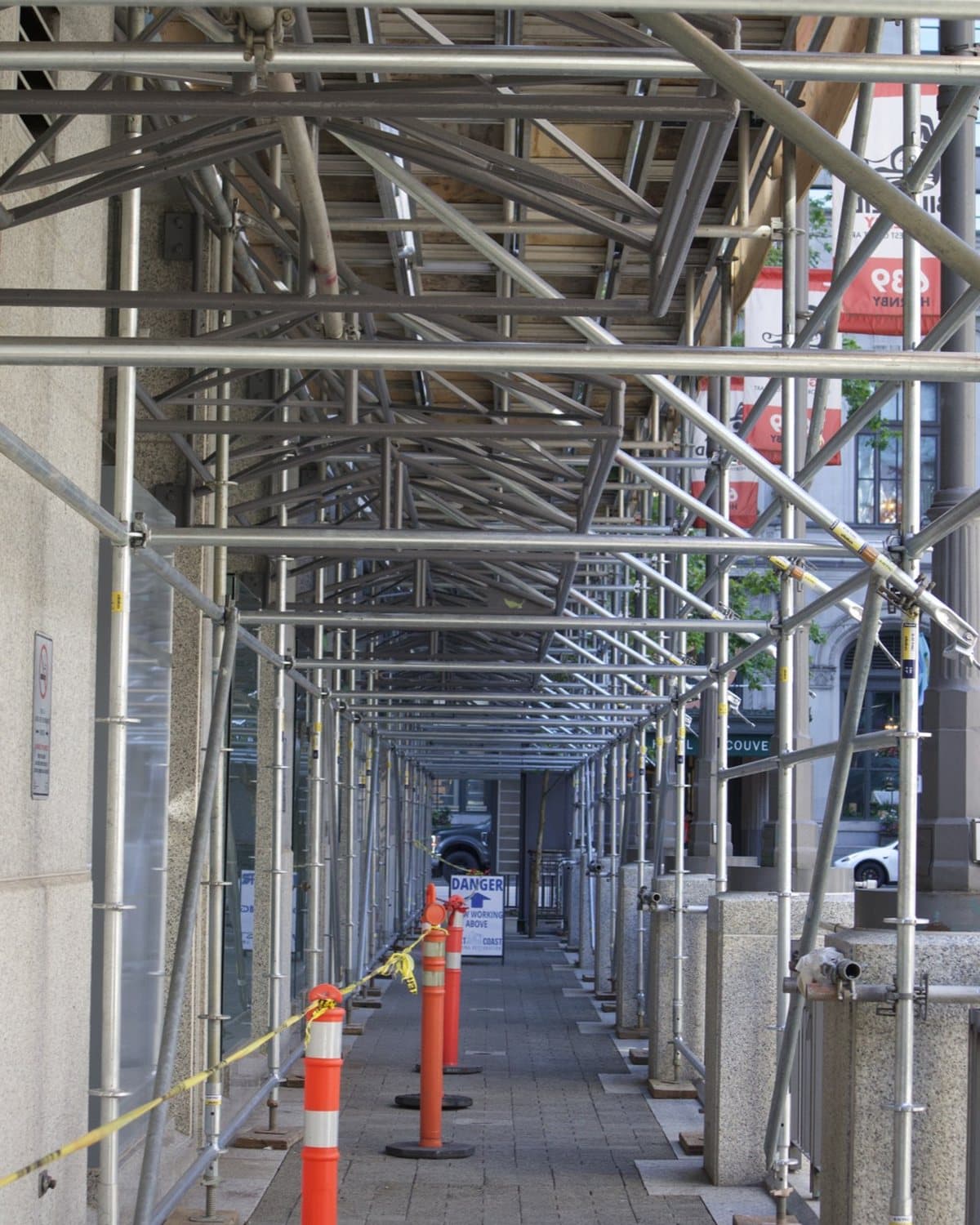 Scaffold canopy over a public sidewalk during sealant replacement at Cathedral Place, Vancouver